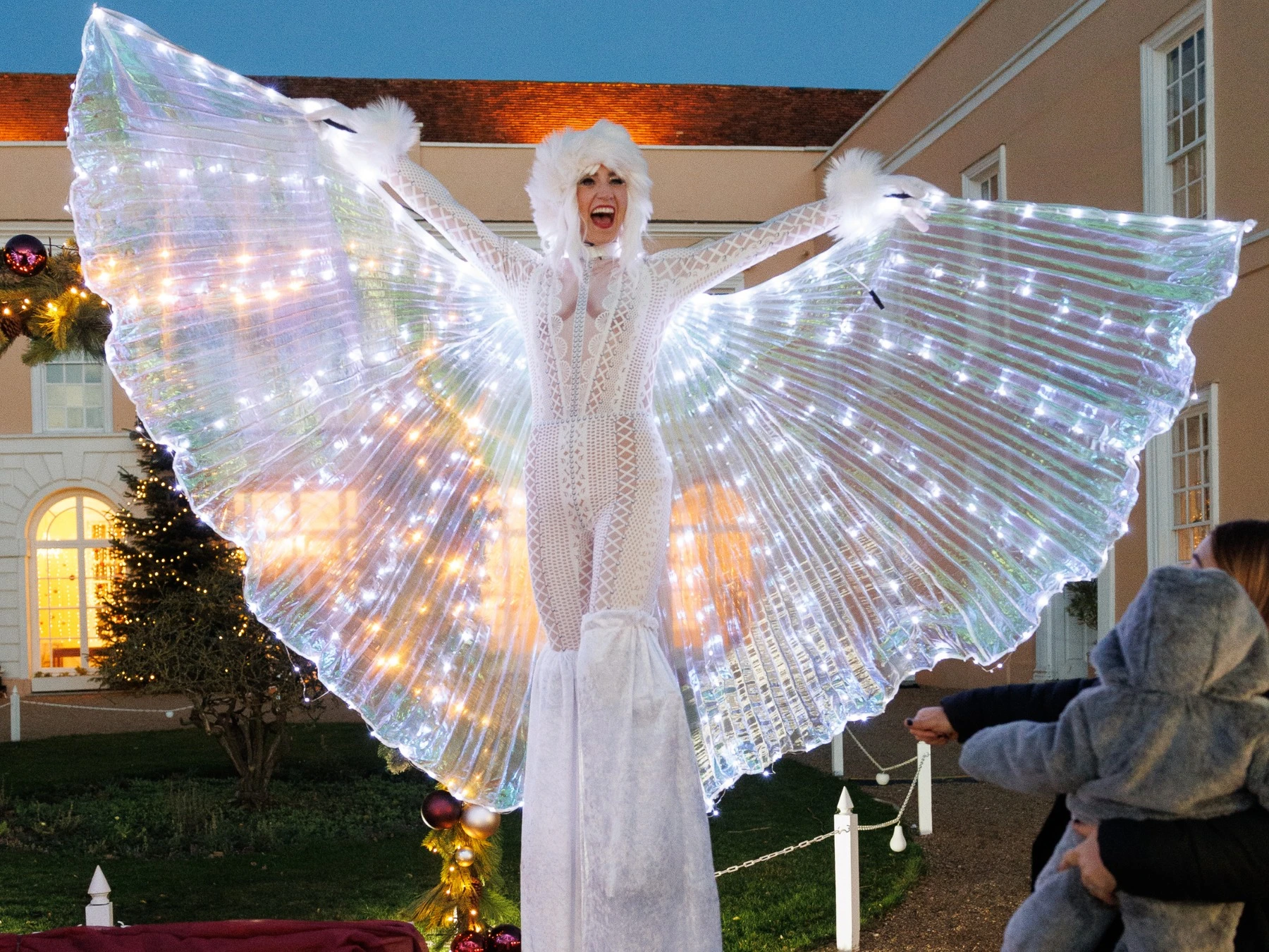 Illuminated Christmas stilt performer at the Suffolk County Christmas Fair