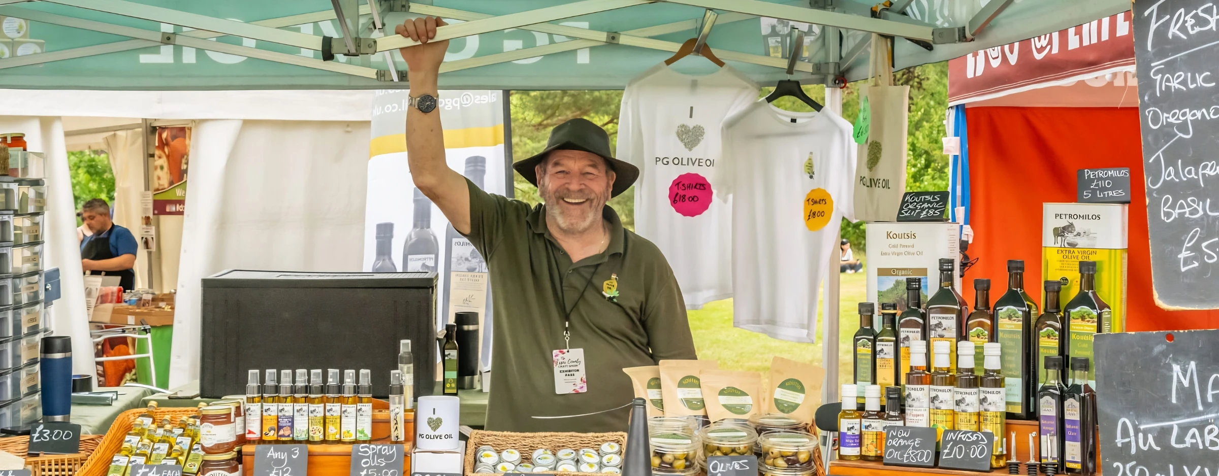Independent stallholder welcoming visitors at a Prestige County Events market